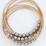 Boho Layered Spring Coil Guitar String Bracelet Set In Gold - Infinity Raine