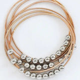 Boho Layered Spring Coil Guitar String Bracelet Set In Gold - Infinity Raine